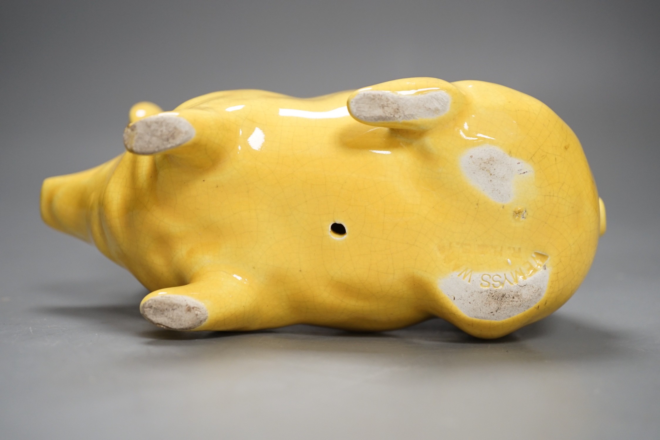 A Wemyss ware yellow glazed pig, 17cms long